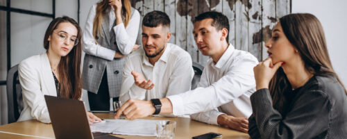 Group of people working out business plan in an office Group of people working out business plan in an office